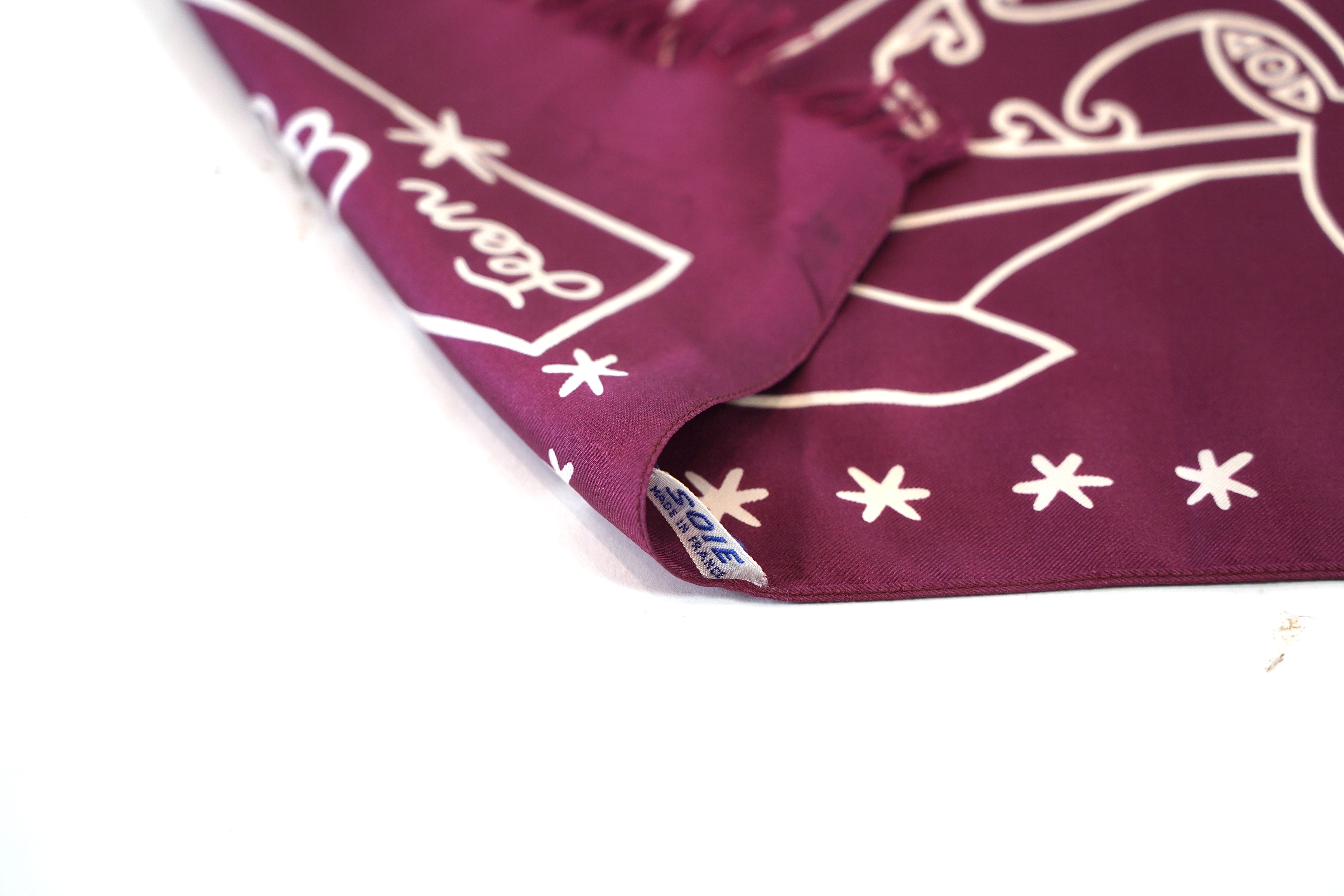 A Yves Saint Laurent silk scarf, a Jean Cocteau zodiac design silk scarf and a Rodier silk scarf.